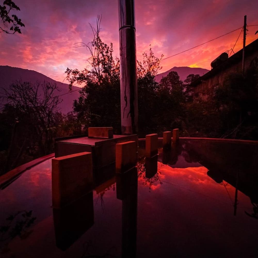 La tinaja al atardecer, con el cielo encendido reflejado en el agua